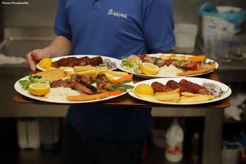 Plates arriving at a taverna table in Chania