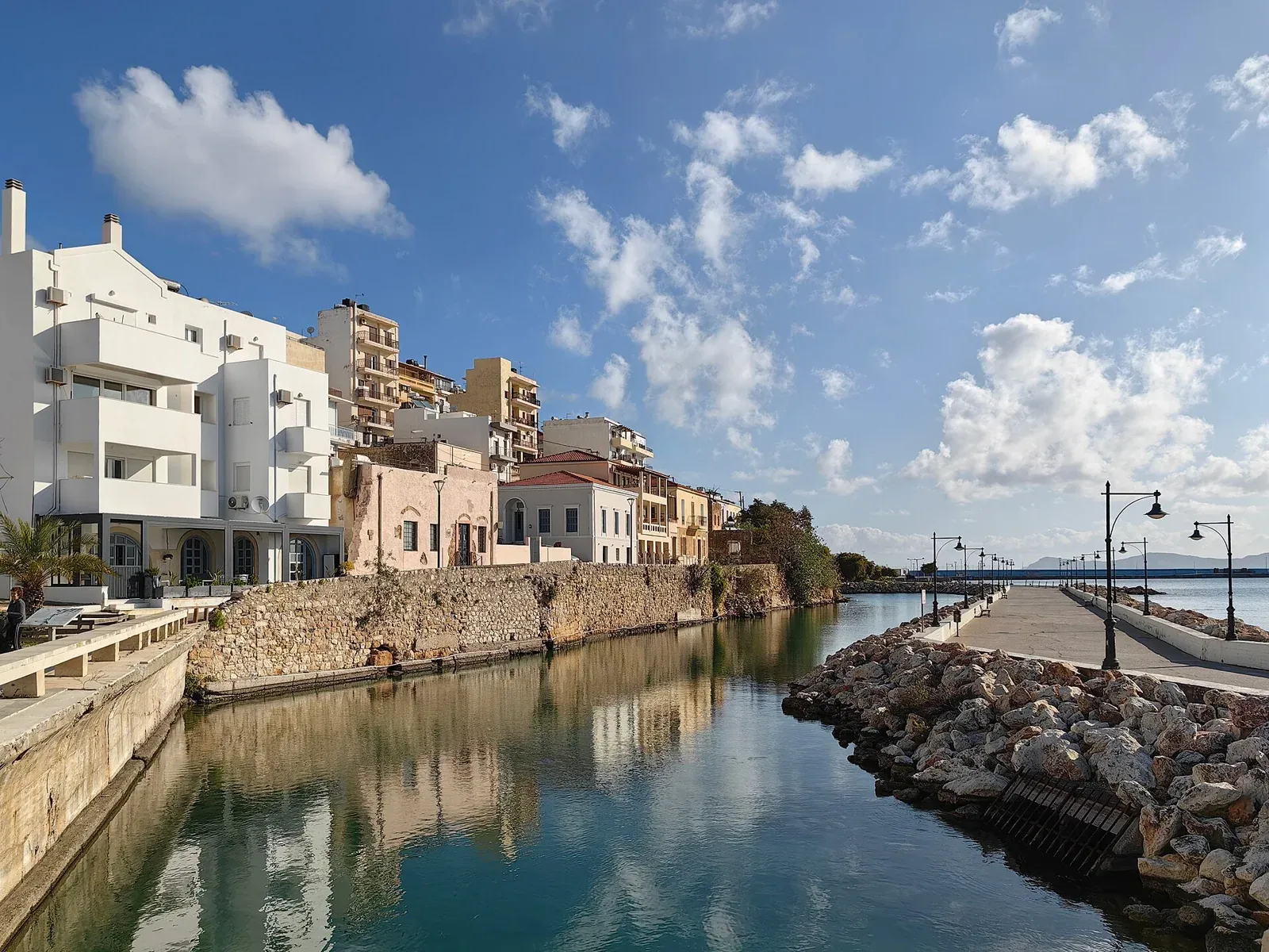 Buildings and small boats beside the port of Sitia